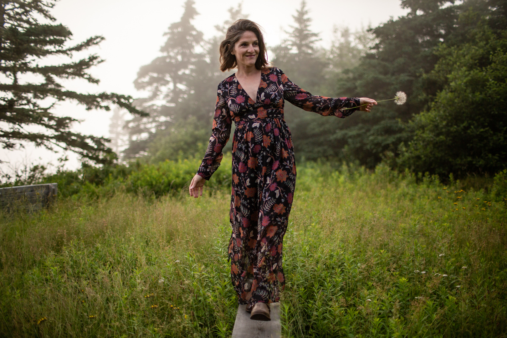 Kate walking on bench with dandelion
